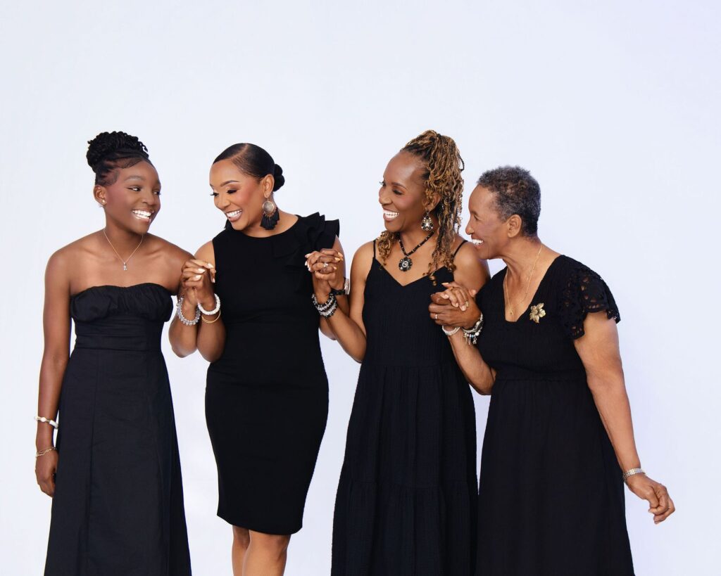 Four generations of women laughing together