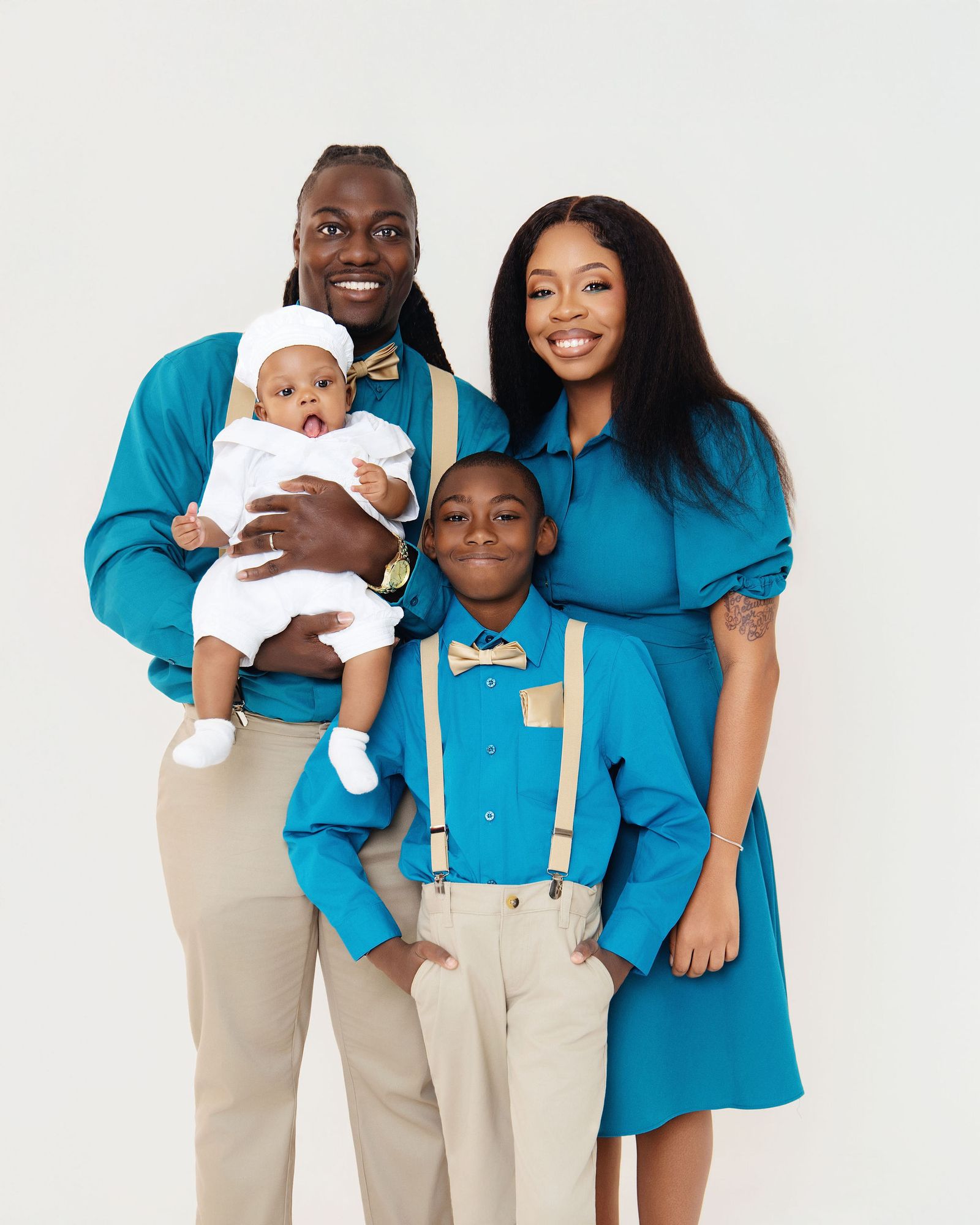 Family portrait in teal with their baby