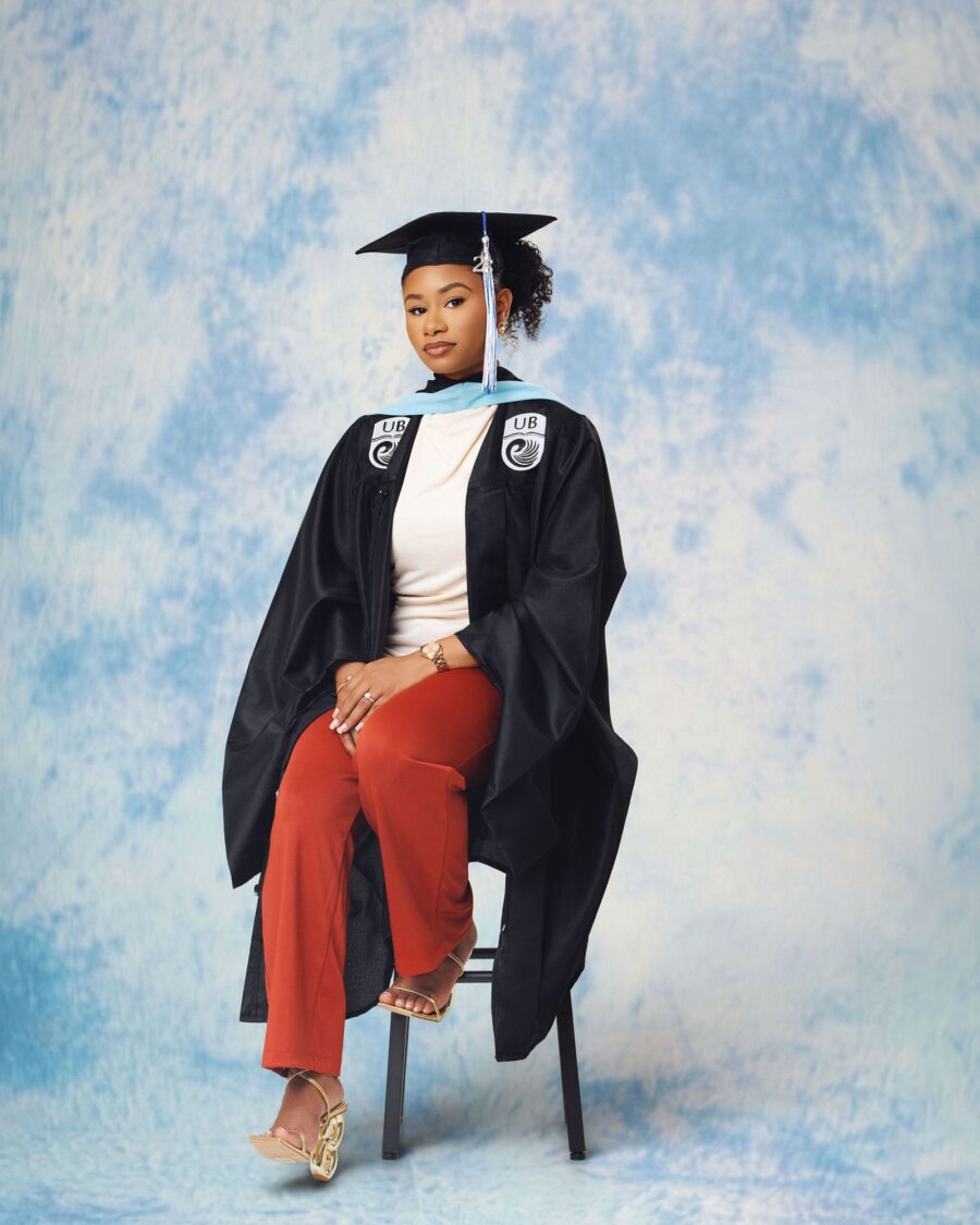 Graduate seated in gown and cap