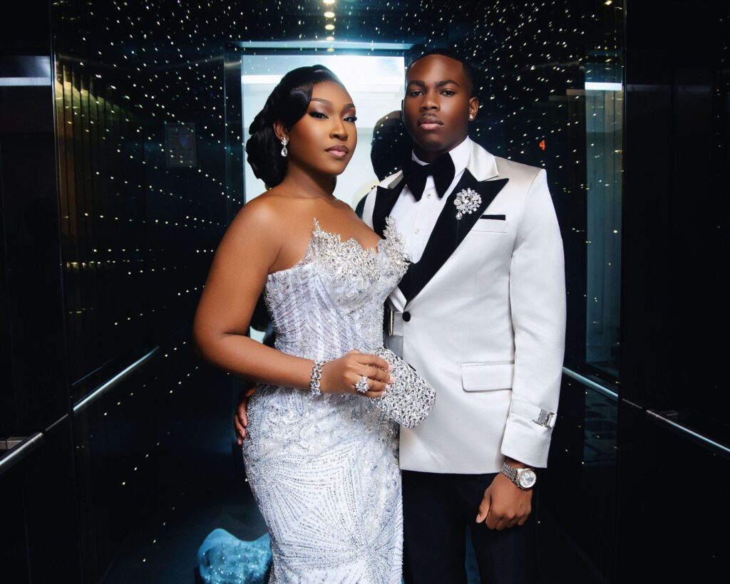 Prom couple in a mirrored elevator